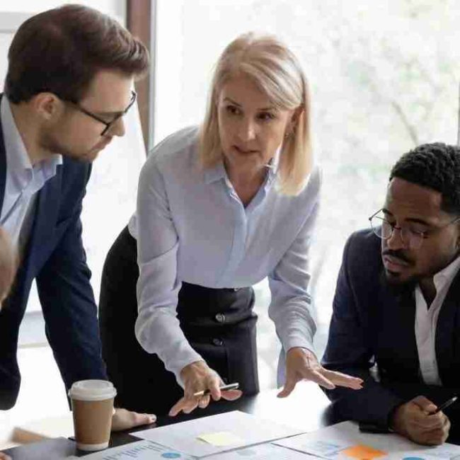 outsource team of employees discussing over a plan